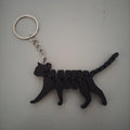 Chaveiro gato articulado impresso em 3D em filamento PLA preto, vista frontal com argola metálica